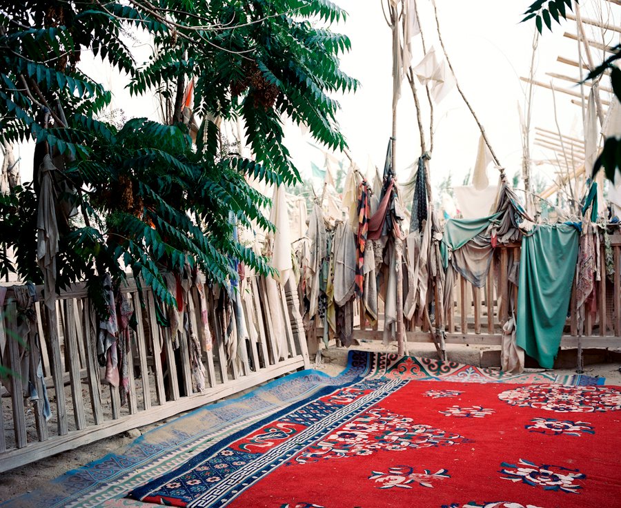 The Imam Asim Tomb is a popular pilgrimage site were you likely see groups of Uighur praying and chanting at the desert shrine, which is slowly being engulfed by the Taklamakan Desert. The Imam (Islamic Holy Man) Asim is said to have been one of the first Islamic missionaries in the region in 1000 AD. The shrine site includes the reputed tomb of the Imam, a mosque, and several related tombs. Jiyà. Xinjiang, China