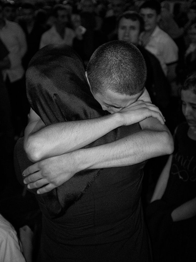 TURKEY. Kayseri. July 2019. A mother hugs her son at a bus station, as he goes to do his compulsory military service. In this country constantly in turmoil, these departures are always a heartbreaking moment for the families and the young conscripts.